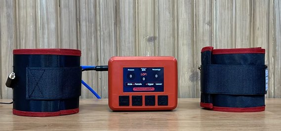 The blood flow restriction device: control box with touchscreen between two limb cuffs